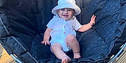 Angus joined the competition — help win amazing prizes! baby, child, smiling, hat, white_clothing, chair, outdoor, wooden_floor, cushion, happy, person, sunlight, deck, can, beverage, relaxing, summer, cute, seat, playful