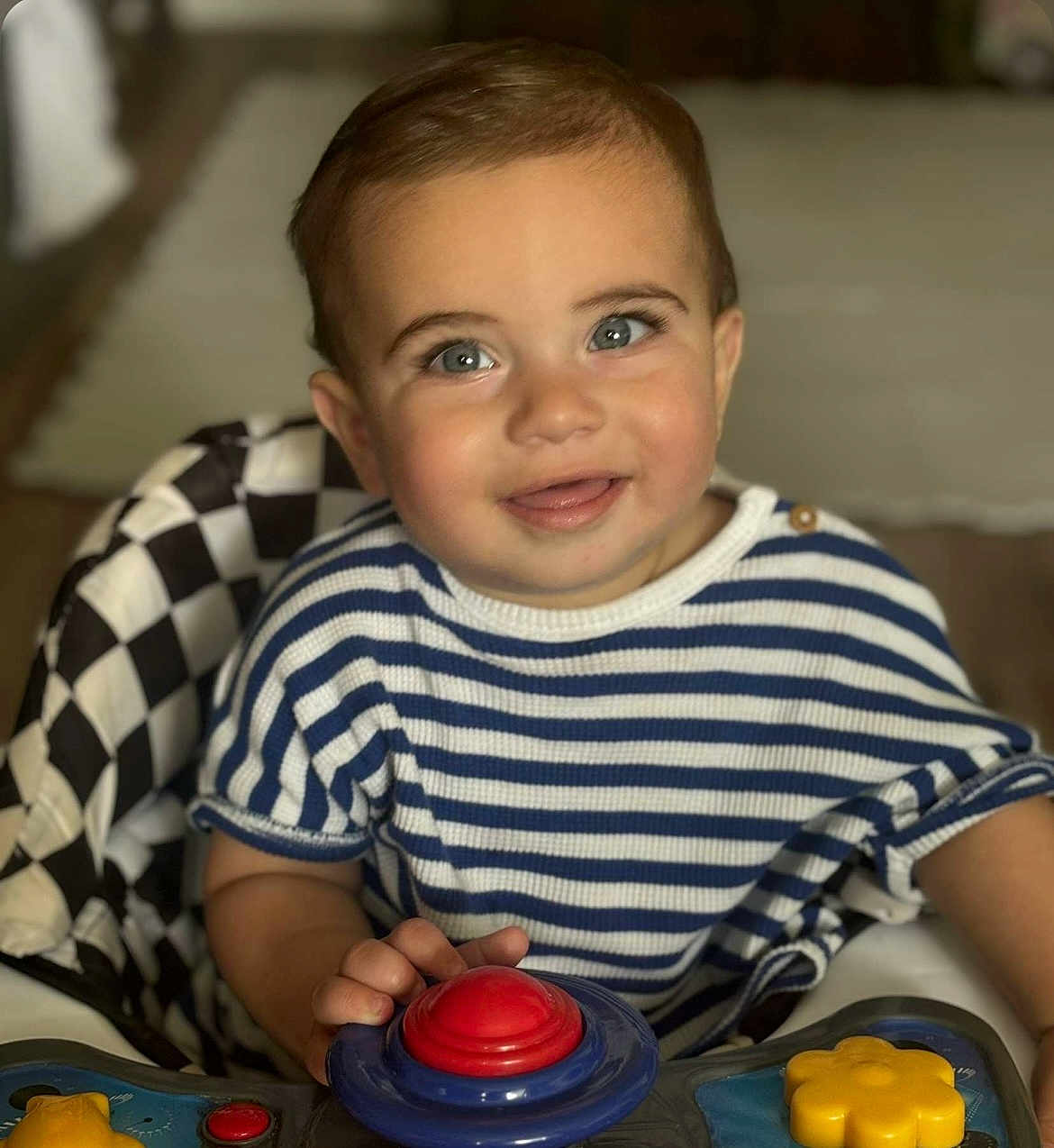 Angus joined the competition — help win amazing prizes! toddler, child, baby, smiling, face, striped_shirt, blue_and_white, button, toy, hand, high_chair, checkered_pattern, indoor, happy, cute, playing, young_child, portrait, person, seated