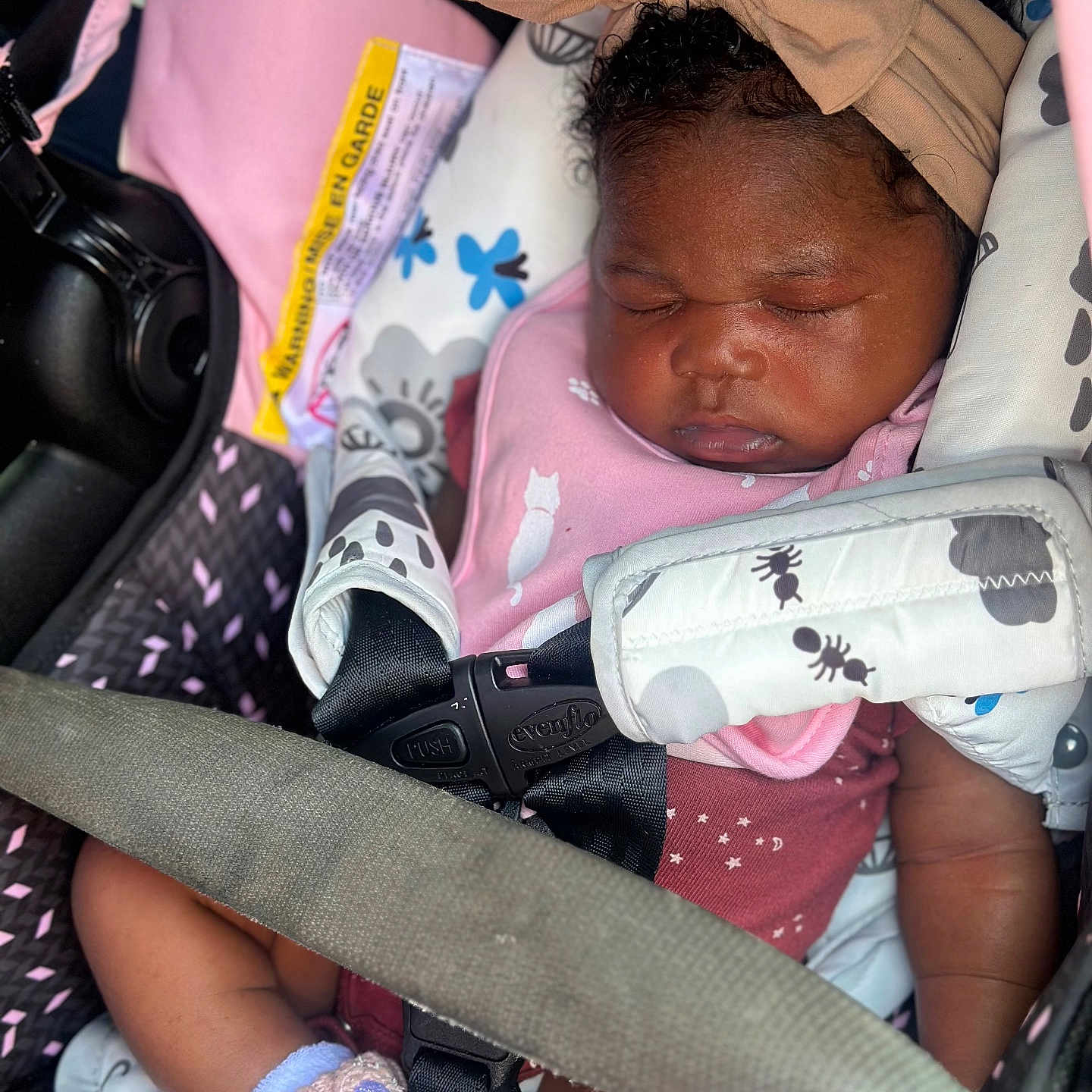 Jazani is registered to the contest to win money with this photo: baby, bow, car_seat, child, clothing, cute, footwear, headband, indoors, infant, maroon, patterned, peaceful, pink, portrait, safety_harness, seatbelt, sleeping, toddler, unicorn_booties