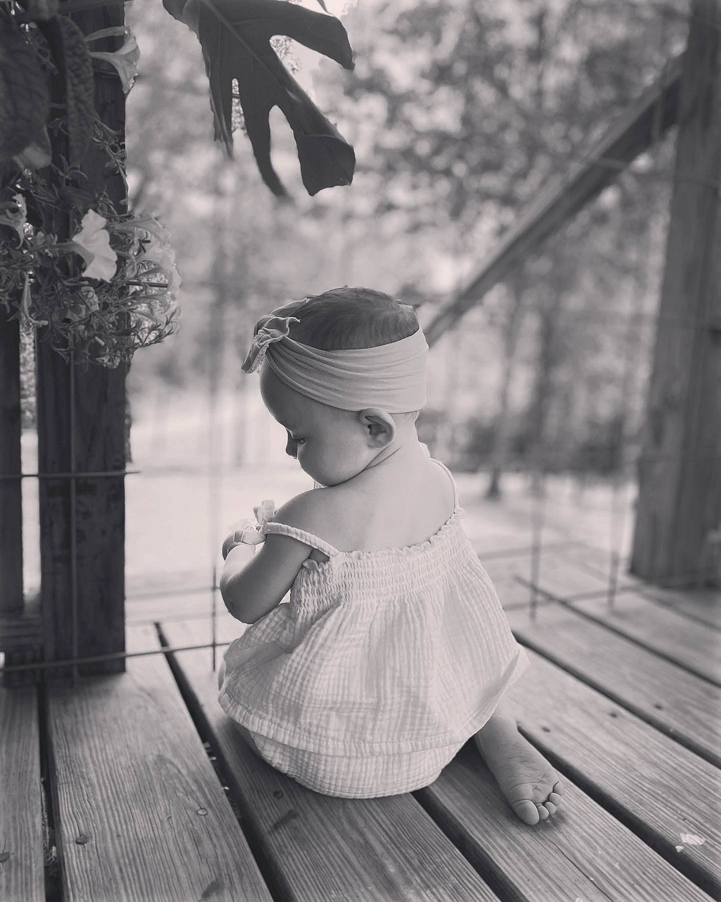 Adalynn joined the competition — help win amazing prizes! black_and_white, boardwalk, deck, fashion_accessory, flooring, happy, hardwood, hat, monochrome, monochrome_photography, person, plank, plant, portrait_photography, sitting, stock_photography, style, toddler, tree, wood