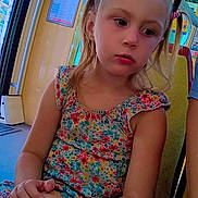 Luna a rejoint le concours — aidez-le/la à gagner de superbes lots ! child, girl, bus, seat, floral_dress, snack, hair_ties, pigtails, indoors, window, yellow_seat, thoughtful, casual_clothing, daylight, public_transport, hand_holding, colorful, young_child, portrait, heart_emojis