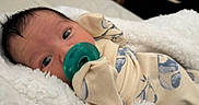 Onyx is registered to the contest to win money with this photo: baby, newborn, pacifier, blanket, bed, infant, clothing, sleeping, face, cute, soft, resting, indoors, closeup, person, portrait, young, child, cozy, comfort