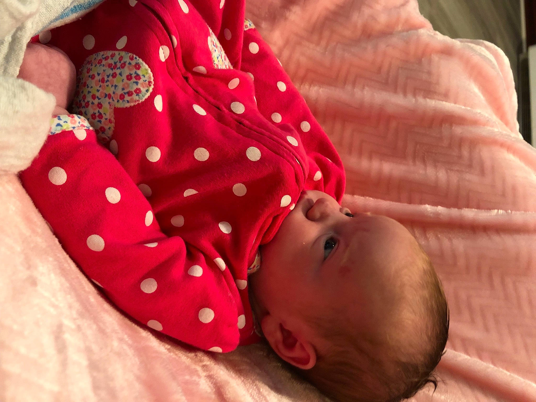 Mackenzie is registered to the contest to win money with this photo: baby, baby_sleeping, baby_toddler_clothing, bedding, bedtime, child, comfort, finger, linens, lip, orange, pattern, people, person, petal, pink, room, skin, sleeve, textile