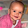 baby, child, closeup, crawling, cute, dimples, eyes, face, happy, head, indoors, infant, jewelry, necklace, person, pink_sweater, portrait, skin, smile, young_child