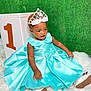 Esperanza participe au concours pour gagner de l'argent avec cette photo : baby_shoes, birthday, block, blue_dress, celebration, child, cute, dress, floor, green_background, happy, indoor, number_one, party, portrait, sitting, smiling, tiara, toddler, white_rug