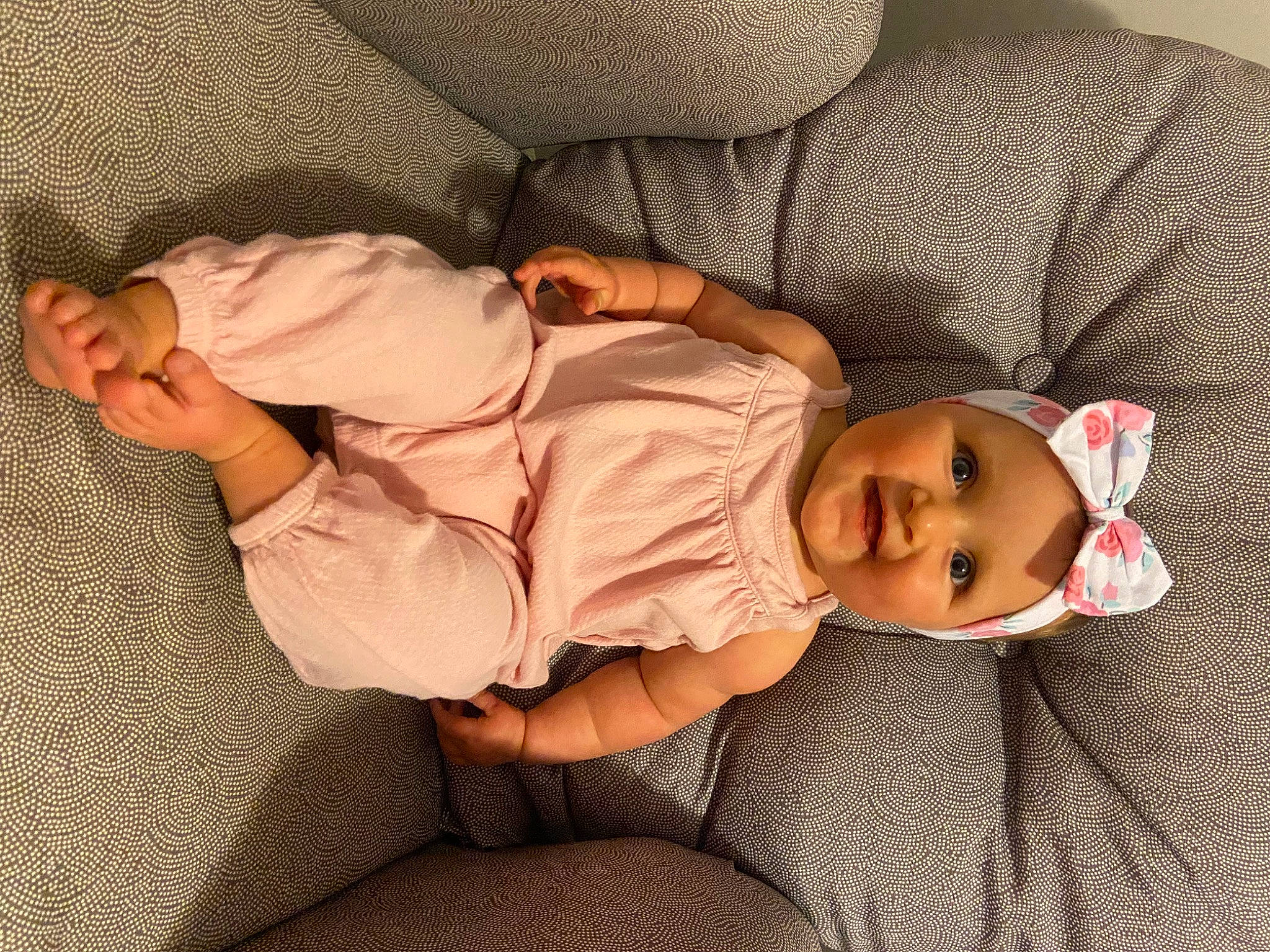 Harlie is registered to the contest to win money with this photo: arm, baby_toddler_clothing, cheek, child, comfort, finger, glasses, headwear, human_body, human_leg, leg, linens, mammal, mouth, person, skin, sleeve, smile, thigh, toddler