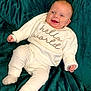 Anastasia joined the competition — help win amazing prizes! baby, infant, smiling, white_clothing, knitwear, blanket, green_blanket, happy, cute, lying_down, child, portrait, indoors, soft_texture, cozy, warm_clothing, newborn, human, face, comfort