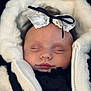 baby, black, bow, child, closeup, clothing, cozy, cute, face, headband, infant, jacket, lace, peaceful, person, portrait, sleeping, soft, warm, white