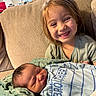 Maliah is registered to the contest to win money with this photo: child, baby, newborn, smile, happy, couch, blanket, indoor, family, sibling, infant, clothing, portrait, person, home, cute, toddler, relaxing, love, cozy