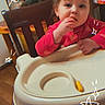 toddler, child, high_chair, snack, red_clothing, indoor, wooden_chair, wooden_floor, face, hand, table, doodle, star_doodle, cute, baby, feeding, furniture, person, smiling, cozy