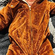 Paisley Rae is registered to the contest to win money with this photo: adorable, baby, blanket, brown, child, clothing, cozy, cute, face, fuzzy, hood, indoors, infant, looking_up, lying_down, onesie, portrait, soft_texture, warm, young