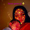 woman, baby, sleeping, face_filter, yellow_flowers, close_up, portrait, text_overlay, indoor, cozy, mother_and_child, affection, love, rest, calm, emotion, dark_background, red_clothing, digital_effect, emoji