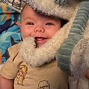 Leo joined the competition — help win amazing prizes! baby, smiling, blanket, soft_toy, tshirt, infant, cute, happy, face, child, cozy, pattern, fabric, portrait, person, closeup, indoor, comfort, playful, sleepwear