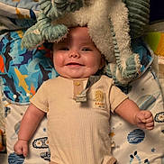 Leo joined the competition — help win amazing prizes! baby, smiling, infant, plush_toy, blanket, space_theme, clothing, onesie, cute, happy, child, indoor, portrait, soft_toy, fabric, lying_down, head, face, hand, buttoned_clothing