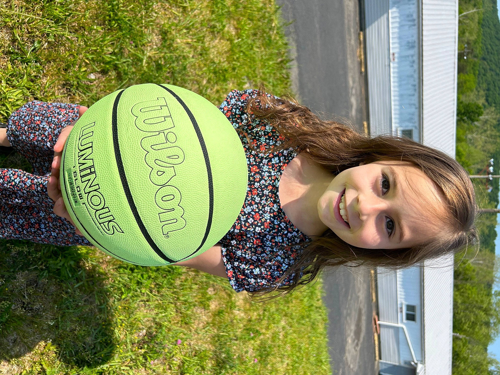 Paislee is registered to the contest to win money with this photo: ball, football, fun, grass, happy, hat, joy, leisure, people_in_nature, person, plant, smile, sports_equipment, sports_toy, toy, tree, wood