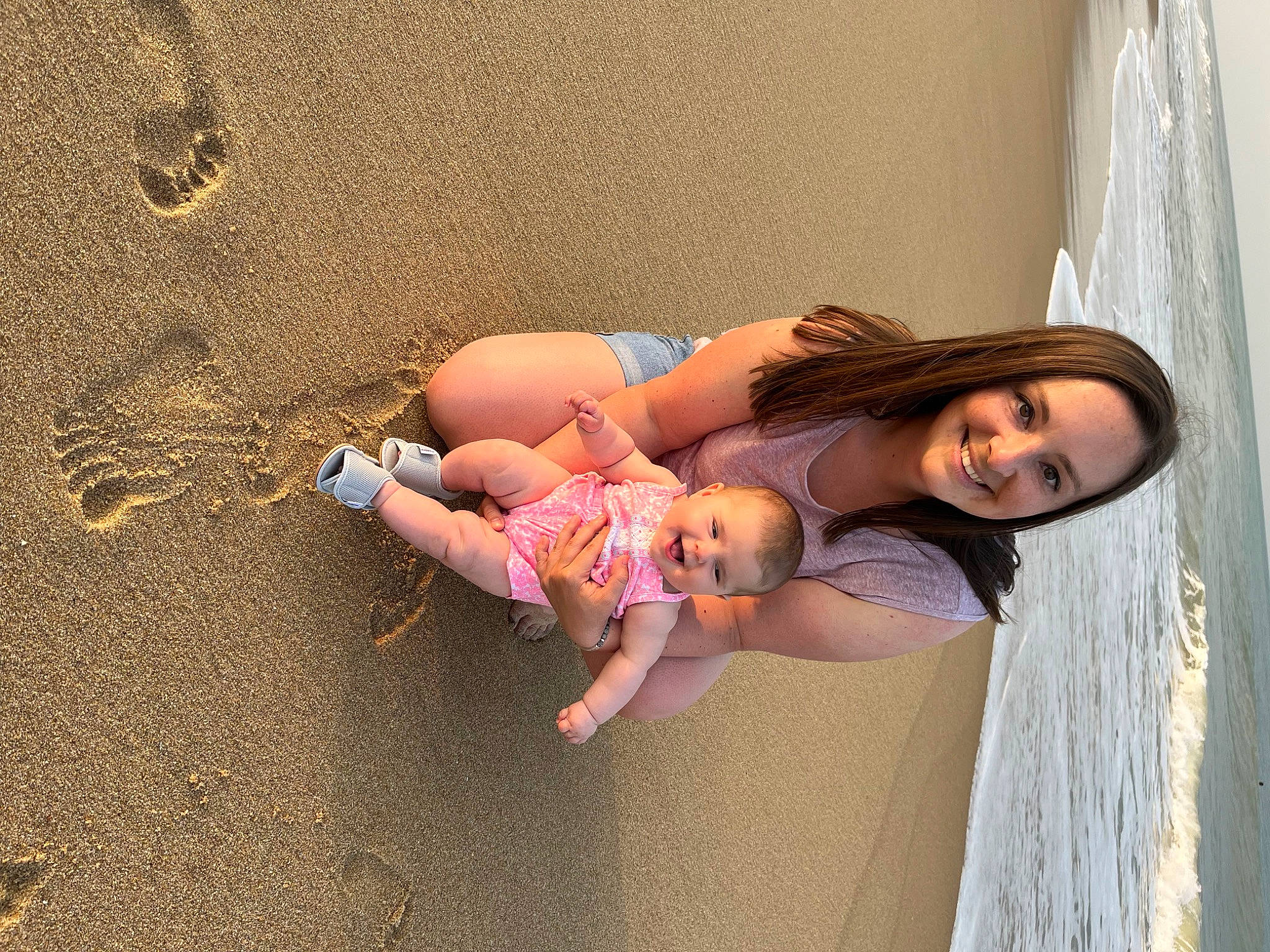 Hadlee is registered to the contest to win money with this photo: arm, barefoot, beach, body_of_water, curtain, dress, foot, fun, happy, human_body, human_leg, joy, leg, leisure, people_in_nature, person, pink, skin, smile, thigh