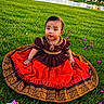 Avika joined the competition — help win amazing prizes! baby, child, grass, greenery, outdoor, traditional_clothing, dress, pond, flower, purple_flower, toy, nature, sunset, cute, sitting, portrait, person, colorful, playful, happy