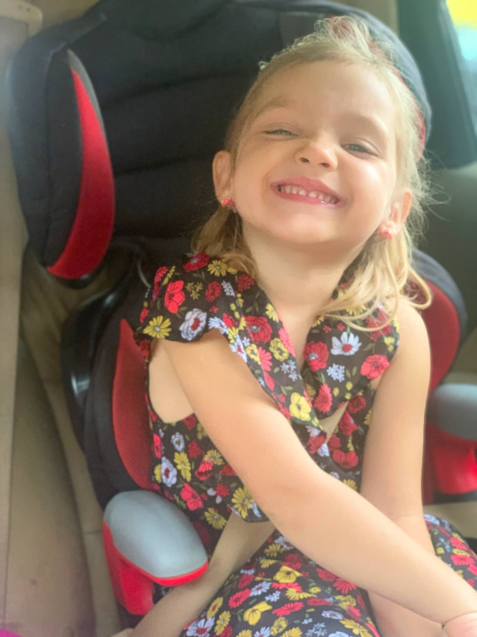 Trinity joined the competition — help win amazing prizes! auto_part, blond, car_seat, child, fun, joy, neck, person, sitting, smile, toddler, vacation