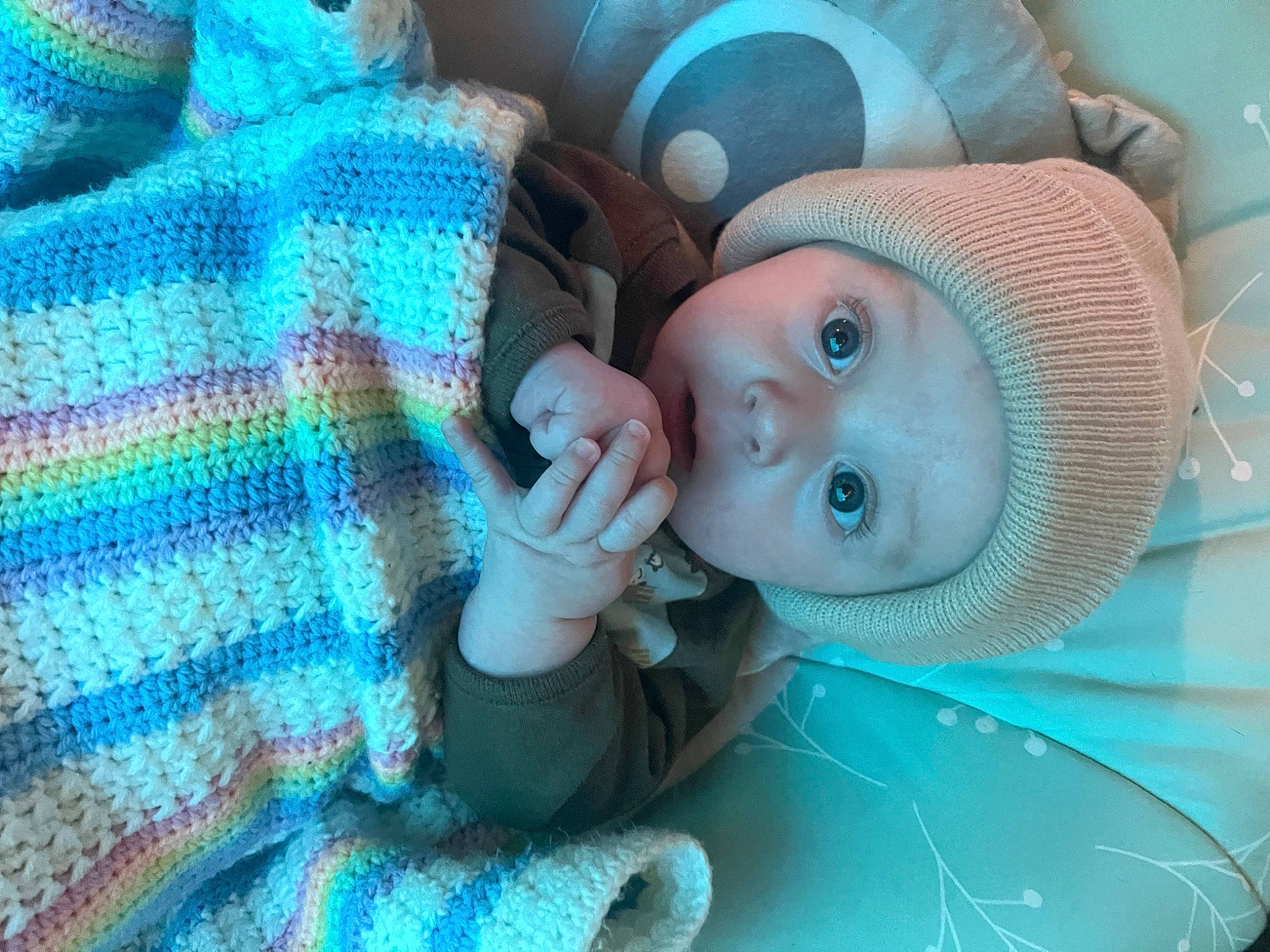 Gatlin is registered to the contest to win money with this photo: aqua, azure, baby, baby_toddler_clothing, blue, cheek, child, close_up, comfort, electric_blue, eye, eyelash, hat, headgear, headwear, iris, linens, nose, person, purple