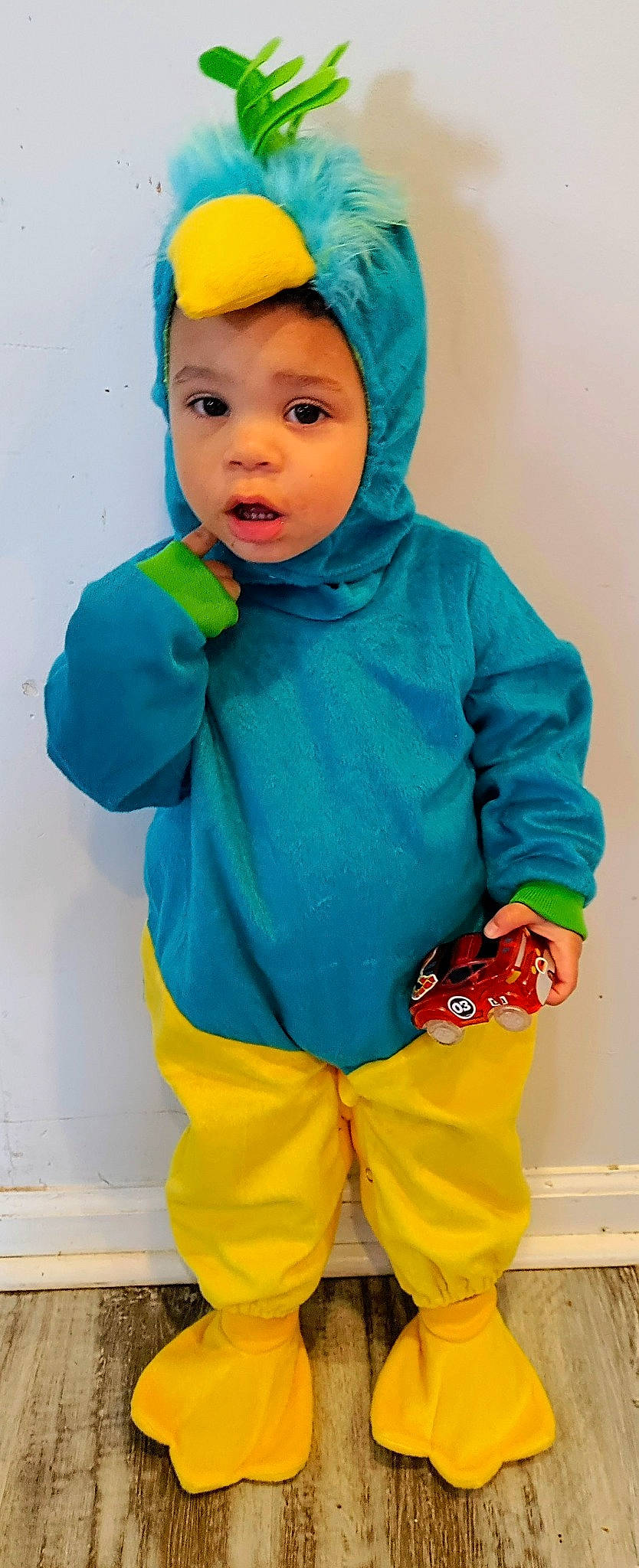 Mayson is registered to the contest to win money with this photo: blue, child, clothing, electric_blue, gesture, green, happy, headgear, headwear, orange, organ, outerwear, people, person, personal_protective_equipment, red, sleeve, standing, surprise, toddler