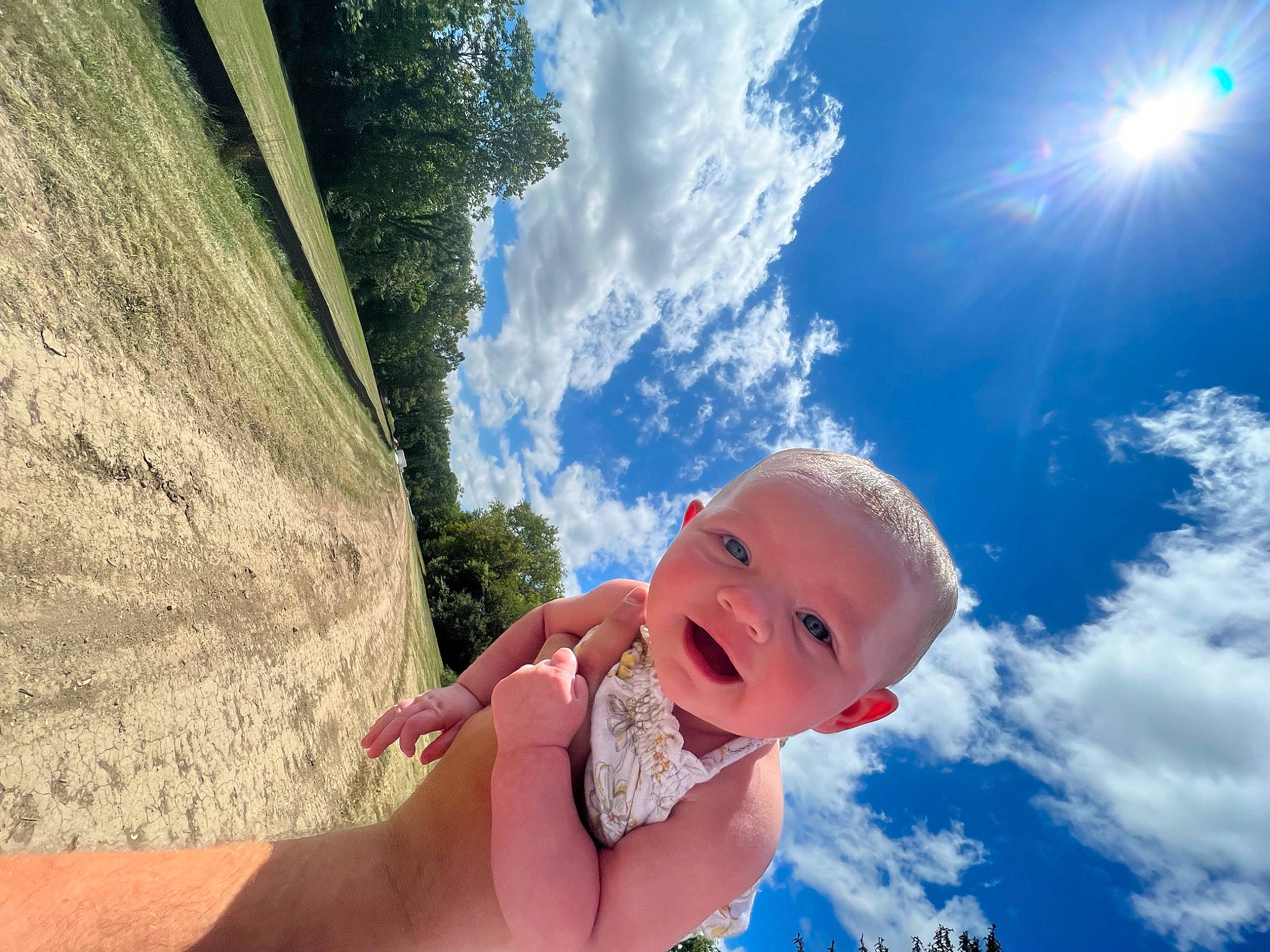 Marilyn is registered to the contest to win money with this photo: azure, baby, cloud, eye, finger, flash_photography, gesture, grass, hand, happy, leaf, leisure, people_in_nature, person, plant, skin, sky, smile, sunlight, toddler