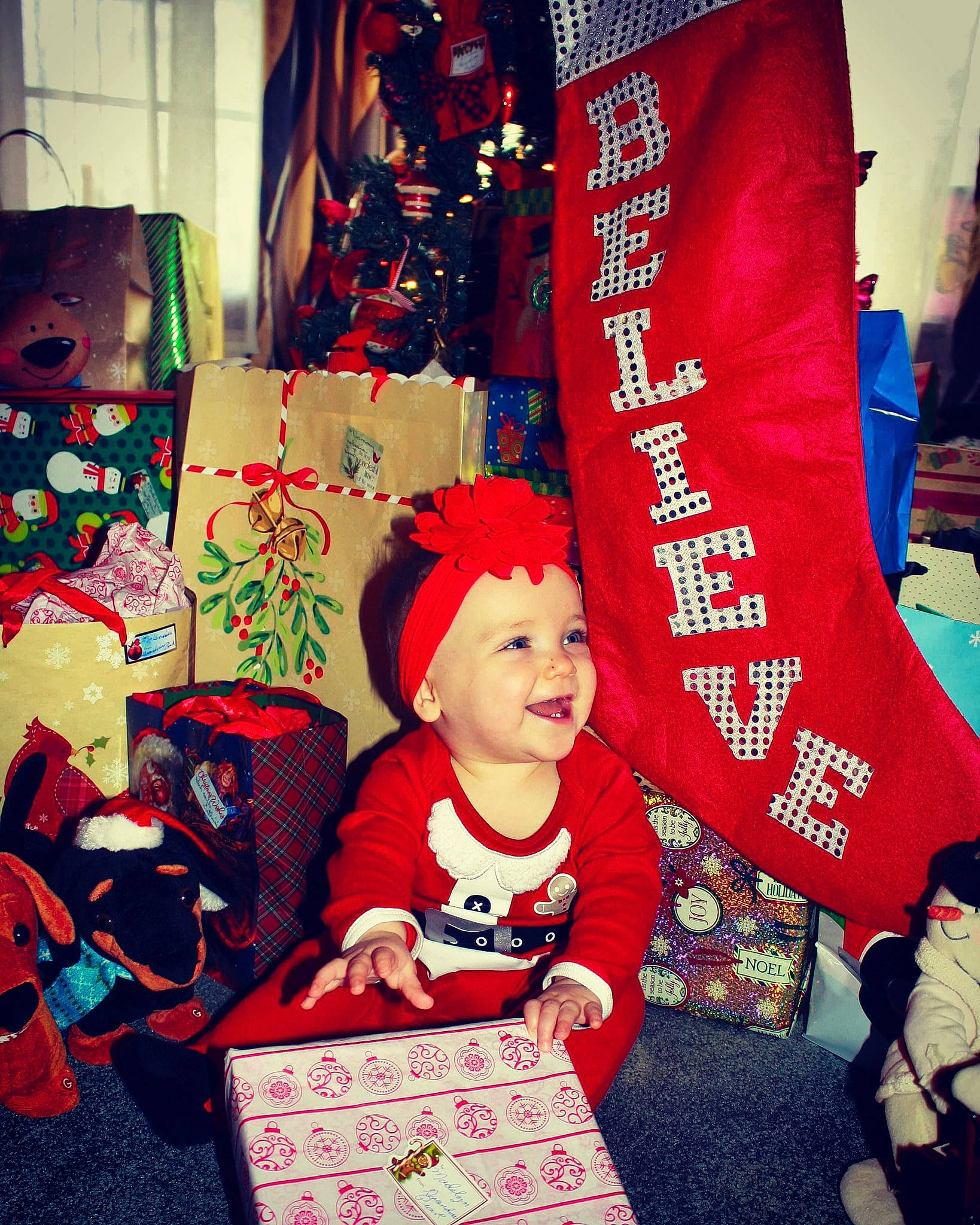 Madelynn joined the competition — help win amazing prizes! child, christmas, christmas_eve, christmas_stocking, event, fictional_character, headwear, holiday, joy, person, red, smile, snapshot, tradition, tree, world