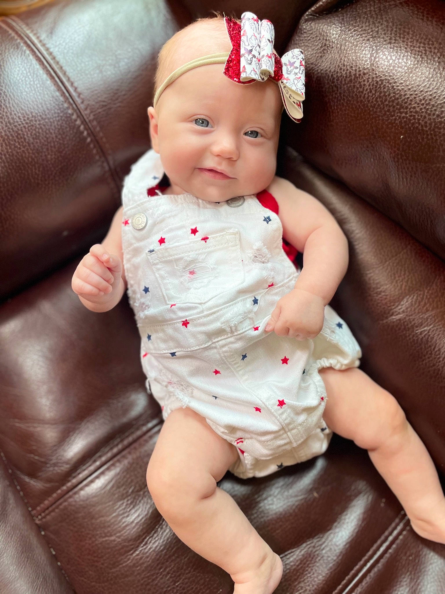 Logann is registered to the contest to win money with this photo: arm, baby, baby_toddler_clothing, cheek, chin, collar, comfort, eye, face, finger, head, headwear, lip, mouth, neck, person, pink, skin, sleeve, textile