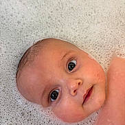 Arabella is registered to the contest to win money with this photo: baby, infant, face, head, eyes, skin, water, bubbles, bath, foam, closeup, portrait, child, cute, wet, expression, young, person, clean, relaxation