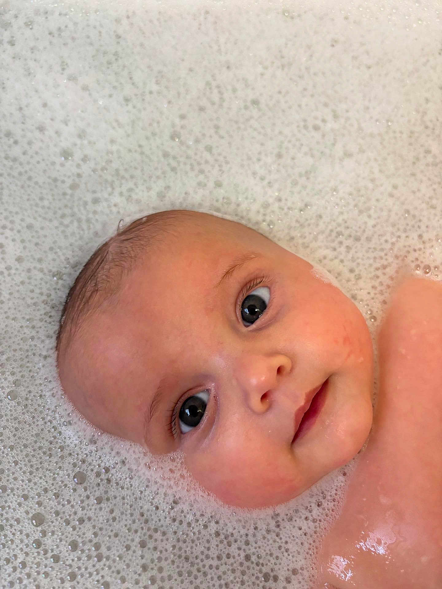 Arabella is registered to the contest to win money with this photo: baby, infant, face, head, eyes, skin, water, bubbles, bath, foam, closeup, portrait, child, cute, wet, expression, young, person, clean, relaxation