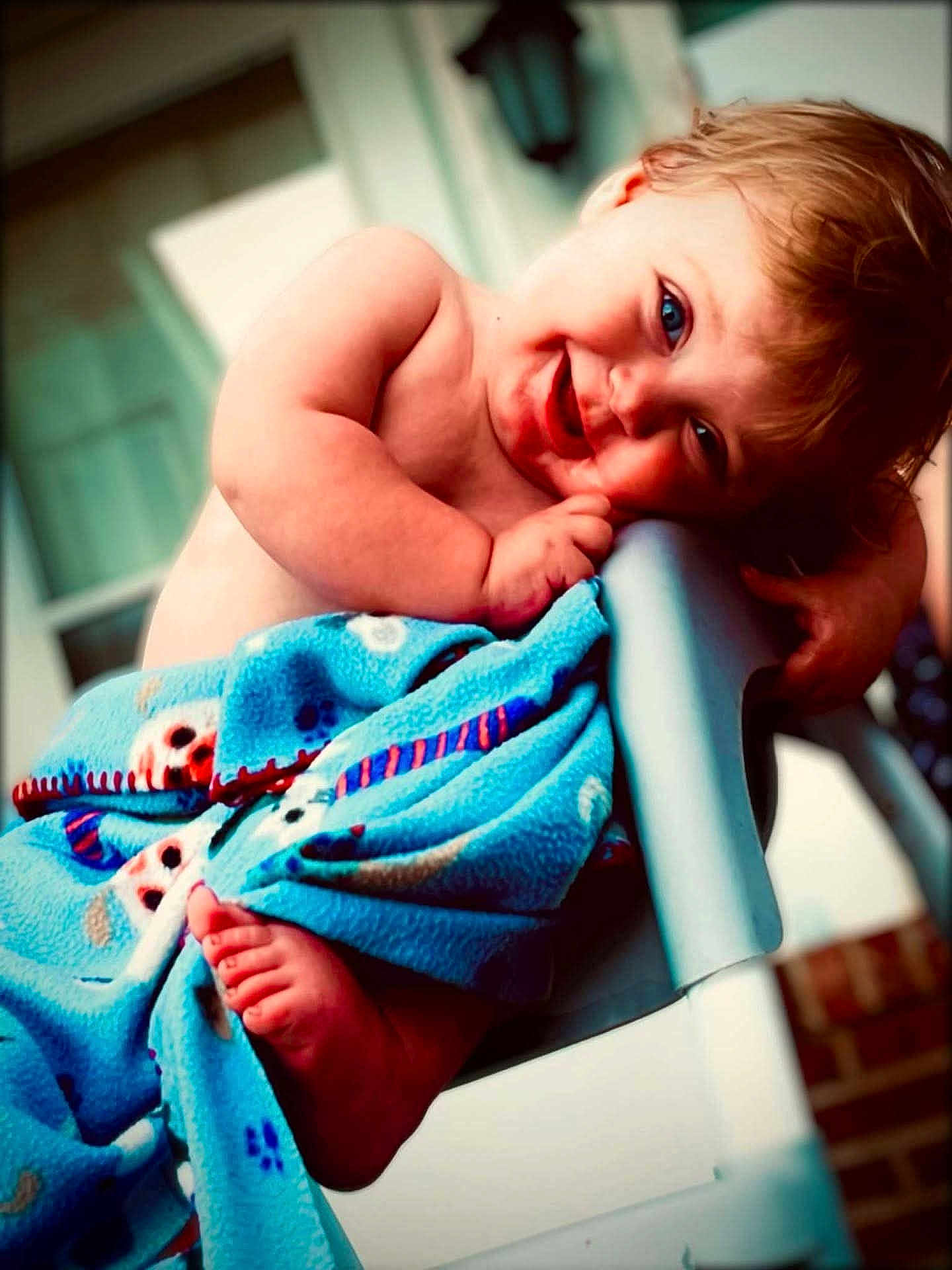 Everleigh is registered to the contest to win money with this photo: baby, child, blanket, blue_blanket, chair, cute, face, feet, foot, hair, happy, indoors, infant, person, playful, portrait, smile, toddler, wrapped, young