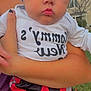 Xavier is registered to the contest to win money with this photo: baby, child, pouty_lips, white_hat, camo_pants, red_pants, black_pants, gray_pants, adult_arm, outdoor, suburban, house, tree, daylight, person, clothing, holding, portrait, cute, face