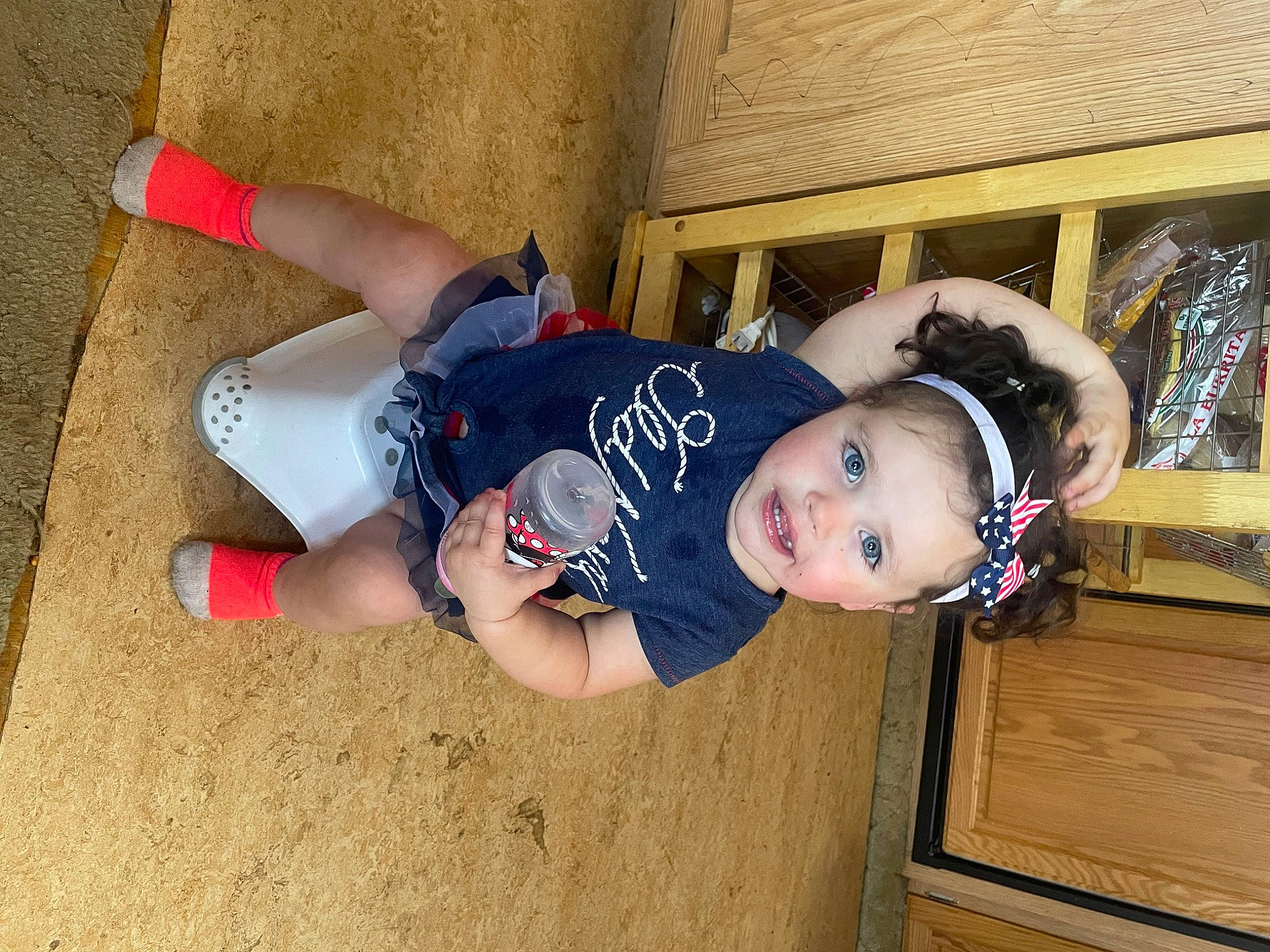 Harlee is registered to the contest to win money with this photo: baby, baby_products, baby_toddler_clothing, carmine, child, fun, happy, person, personal_protective_equipment, sitting, smile, sock, toddler, tree, wood