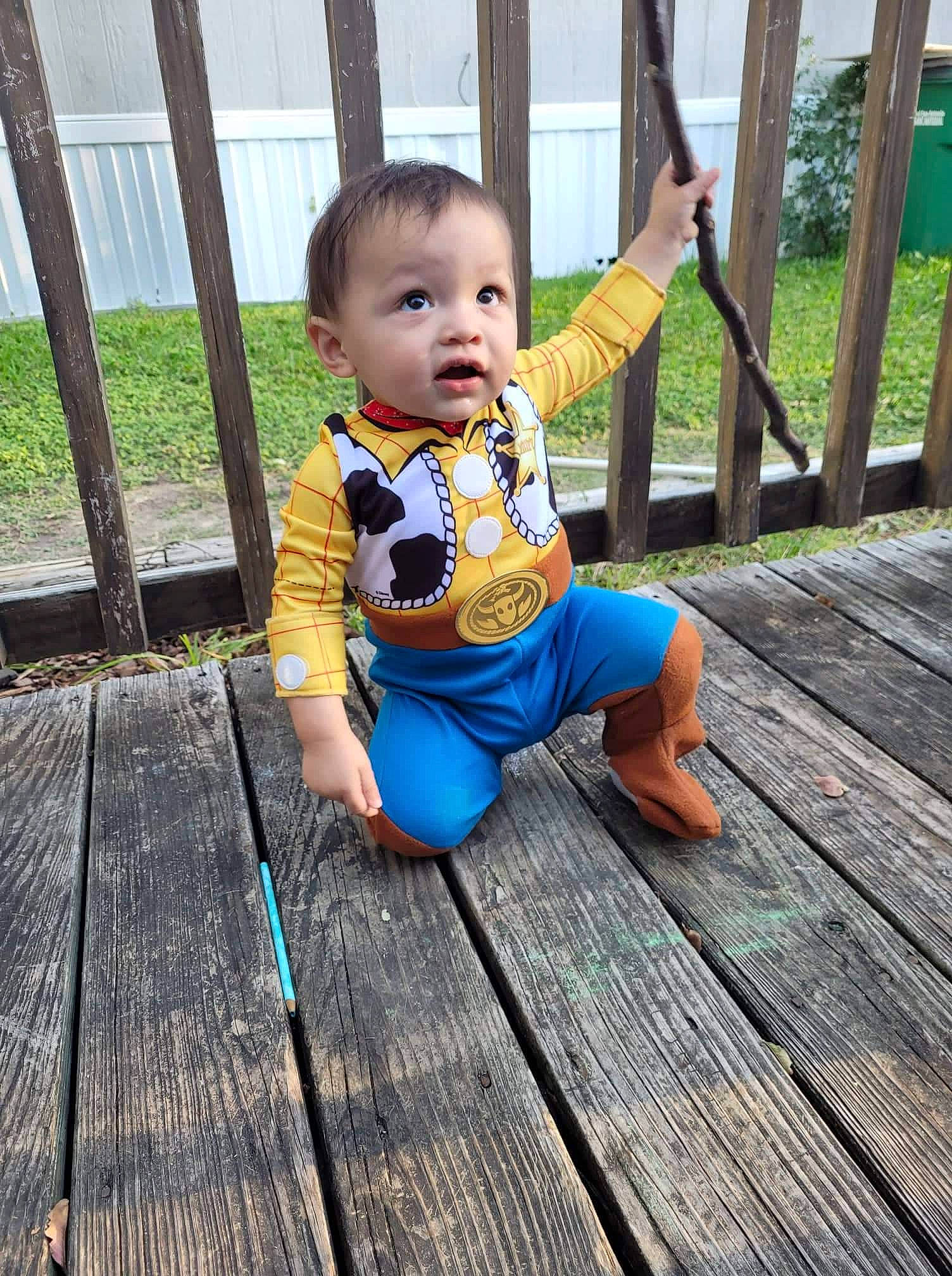 Eleazar is registered to the contest to win money with this photo: baby, baby_toddler_clothing, cheek, child, deck, electric_blue, face, flooring, fun, grass, happy, hardwood, leisure, person, plank, plant, recreation, skin, surprise, toddler