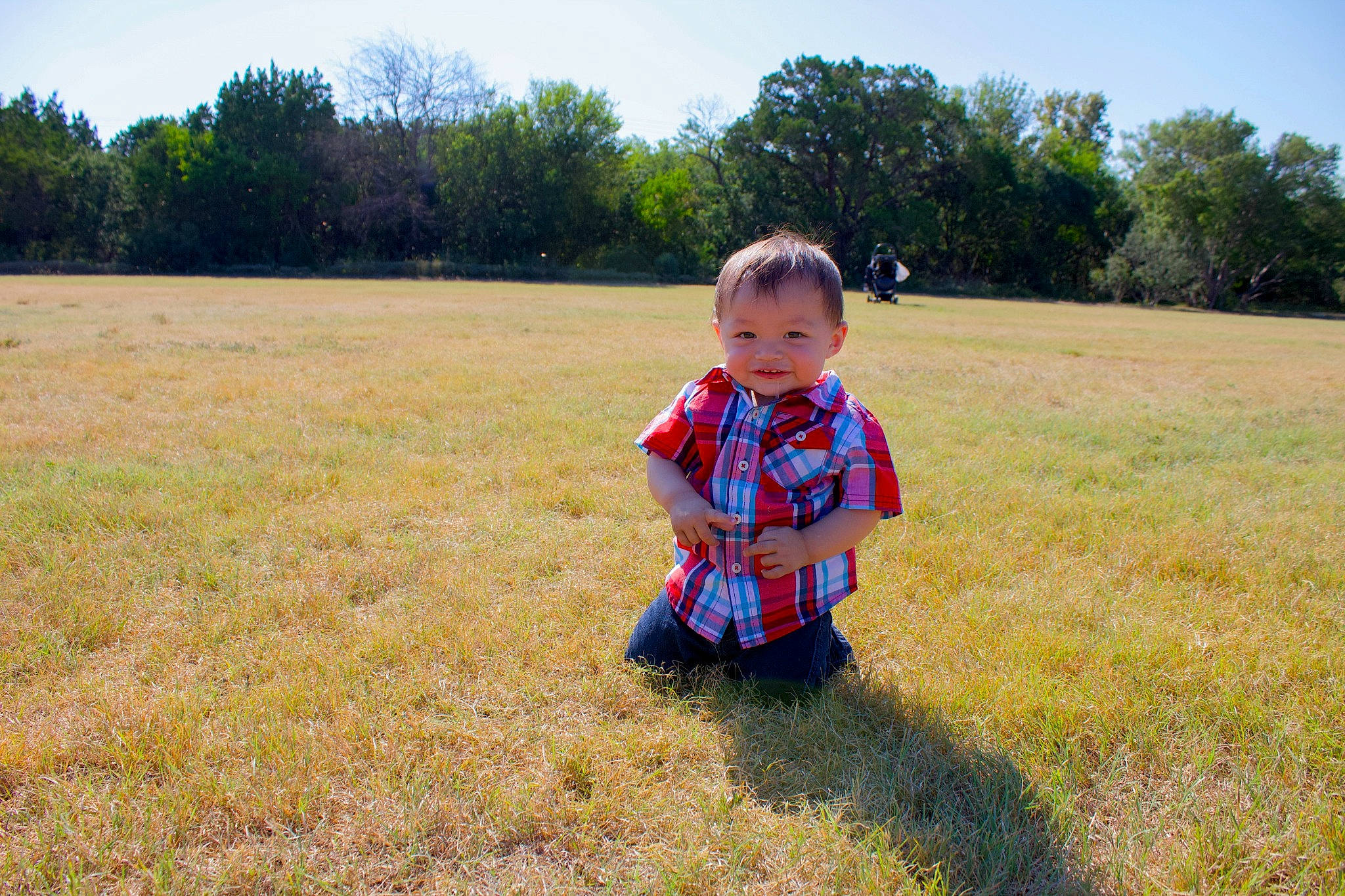 Eleazar is registered to the contest to win money with this photo: agriculture, baby, baby_toddler_clothing, grass, grassland, happy, landscape, lawn, leisure, meadow, natural_landscape, people_in_nature, person, plain, plant, prairie, recreation, sky, summer, toddler