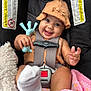 Alani is registered to the contest to win money with this photo: baby, child, car_seat, chicco, hat, toy, giraffe_toy, stuffed_animal, blanket, sock, smiling, happy, infant, seatbelt, clothing, cute, indoor, portrait, closeup, baby_accessory