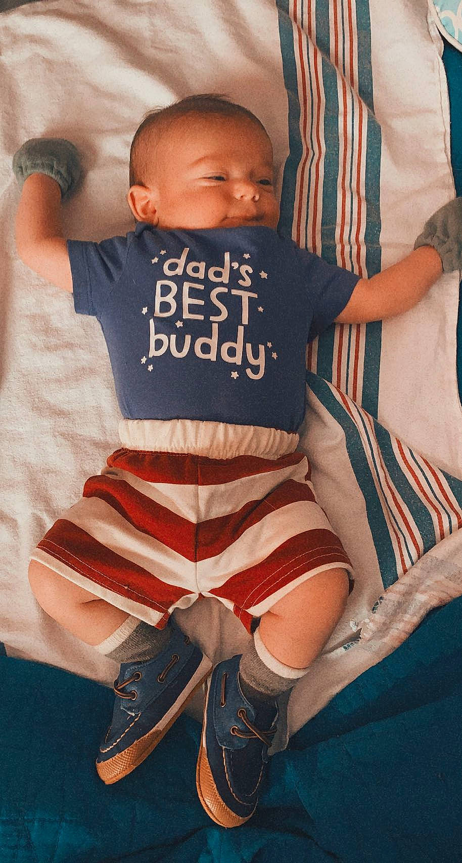 Silas is registered to the contest to win money with this photo: baby, baby_toddler_clothing, comfort, cool, eye, face, head, joint, knee, leg, mouth, muscle, orange, person, product, skin, sleeve, textile, thigh, toddler