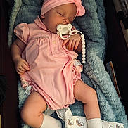 Emerson joined the competition — help win amazing prizes! baby, sleeping, pacifier, headband, pink_clothing, blanket, socks, rainbow_pattern, infant, cute, cozy, resting, soft_texture, child, portrait, indoors, peaceful, newborn, baby_girl, comfort