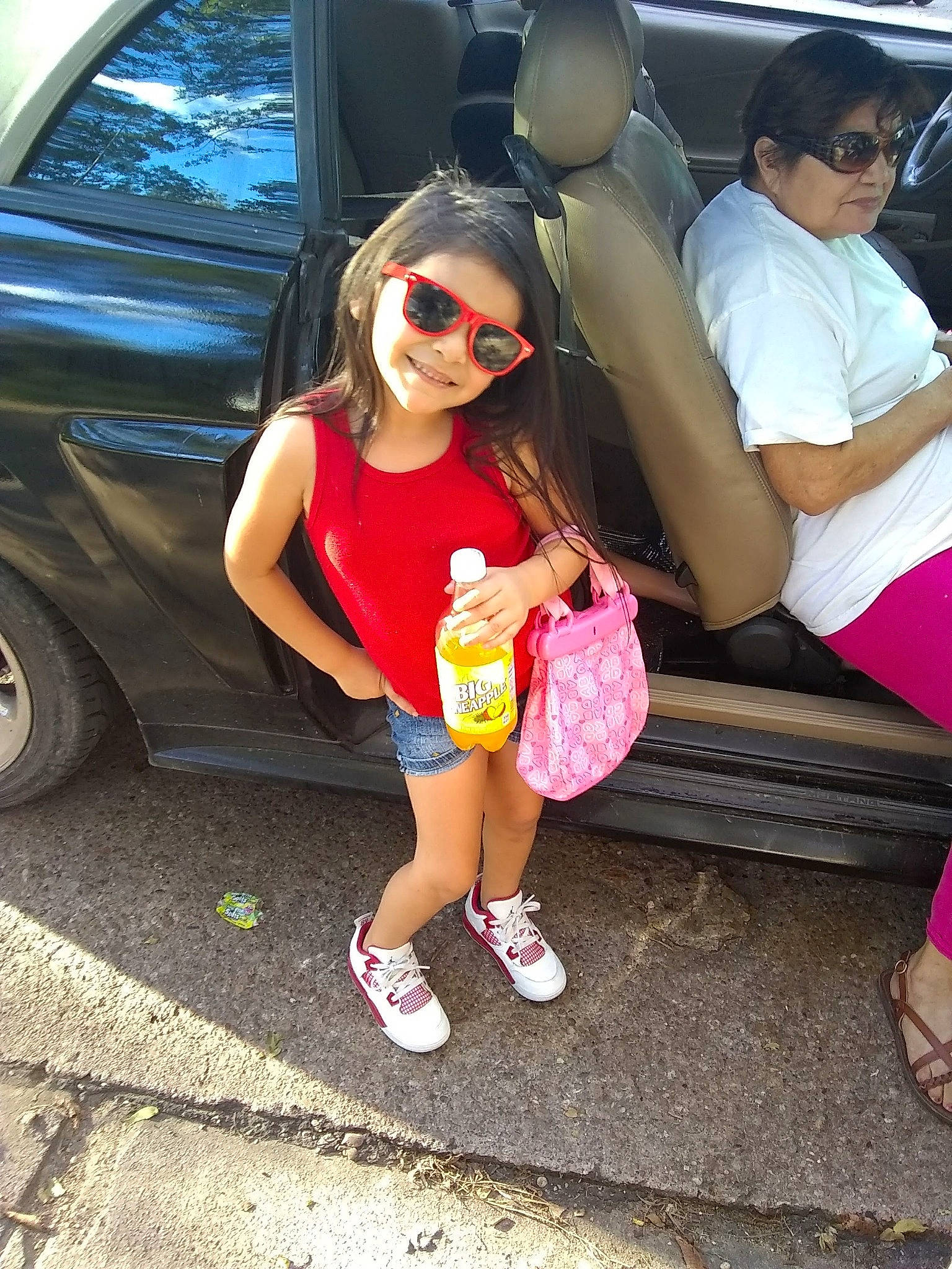 Ari'Bella Chanelle is registered to the contest to win money with this photo: abdomen, car, child, cool, daughter, eyewear, family_car, fun, girl, glasses, joy, leg, person, pink, product, shoe, shoulder, smile, sunglasses, textile