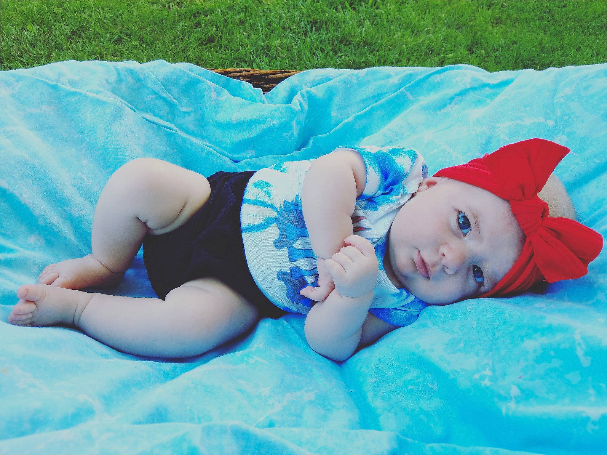 Harlowe joined the competition — help win amazing prizes! azure, baby, baby_toddler_clothing, blue, child, comfort, electric_blue, fun, grass, hat, head, headwear, human_leg, knee, leisure, linens, person, sock, summer, textile