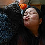 affection, black_dog, candid, casual, curtain, dog, face, furry, home_decor, indoor, long_hair, love, orange_shirt, pet, plush_toy, portrait, puckered_lips, relaxed, window, woman