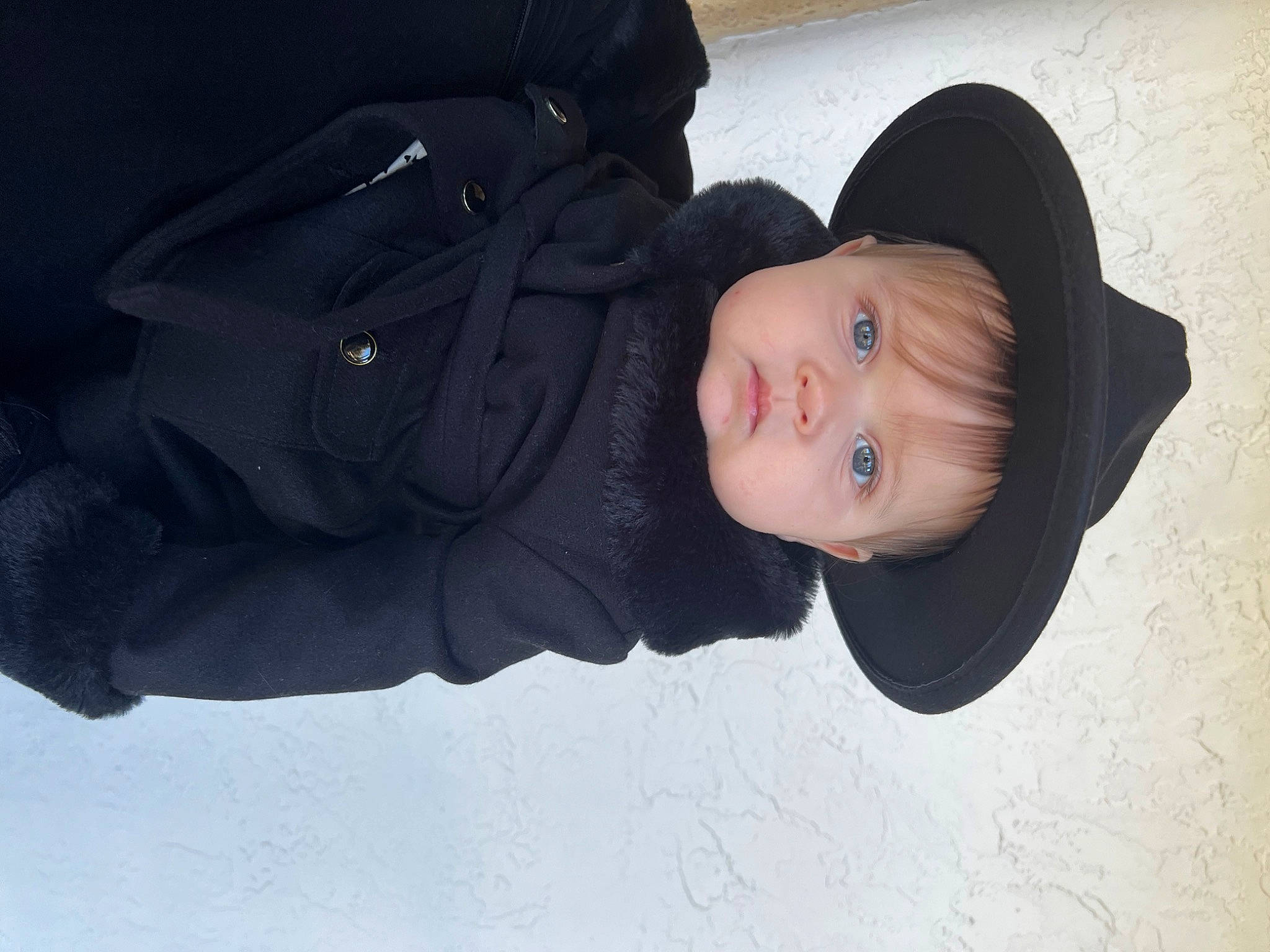 Amalia is registered to the contest to win money with this photo: baby, baby_toddler_clothing, cheek, child, comfort, electric_blue, flash_photography, headgear, person, portrait_photography, sky, sleeve, snow, toddler, tree, winter