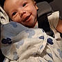 baby, child, infant, blanket, car_seat, smile, face, happy, comfort, clothing, seatbelt, portrait, cute, indoors, young_child, skin, head, expression, cozy, resting