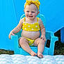 Addileyn joined the competition — help win amazing prizes! baby, child, smiling, yellow_bikini, headband, polka_dot, blue_chair, outdoor, grass, cushion, feet, happy, summer, cute, portrait, infant, playful, sitting, skin, blond_hair