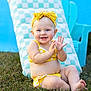 baby, child, smiling, yellow_bikini, headband, polka_dot, grass, outdoor, sunny, blue_eyes, happy, clapping, cheerful, summer, checkered_cushion, blue_chair, cute, sitting, barefoot, portrait
