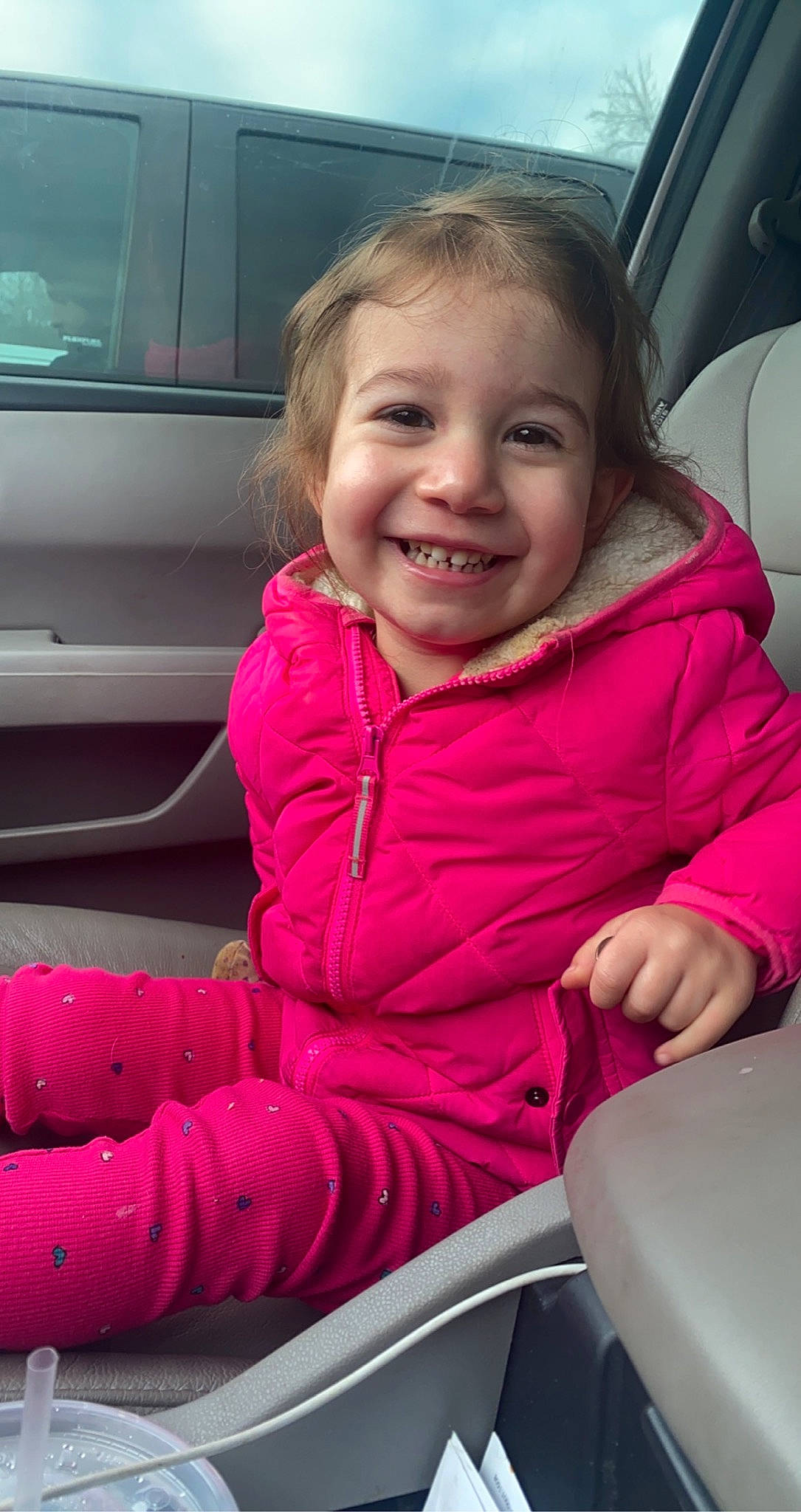 Delilah joined the competition — help win amazing prizes! automotive_design, automotive_exterior, car, car_seat, cheek, eye, face, finger, hairstyle, happy, joy, lip, motor_vehicle, person, pink, skin, smile, steering_wheel, toddler, vehicle