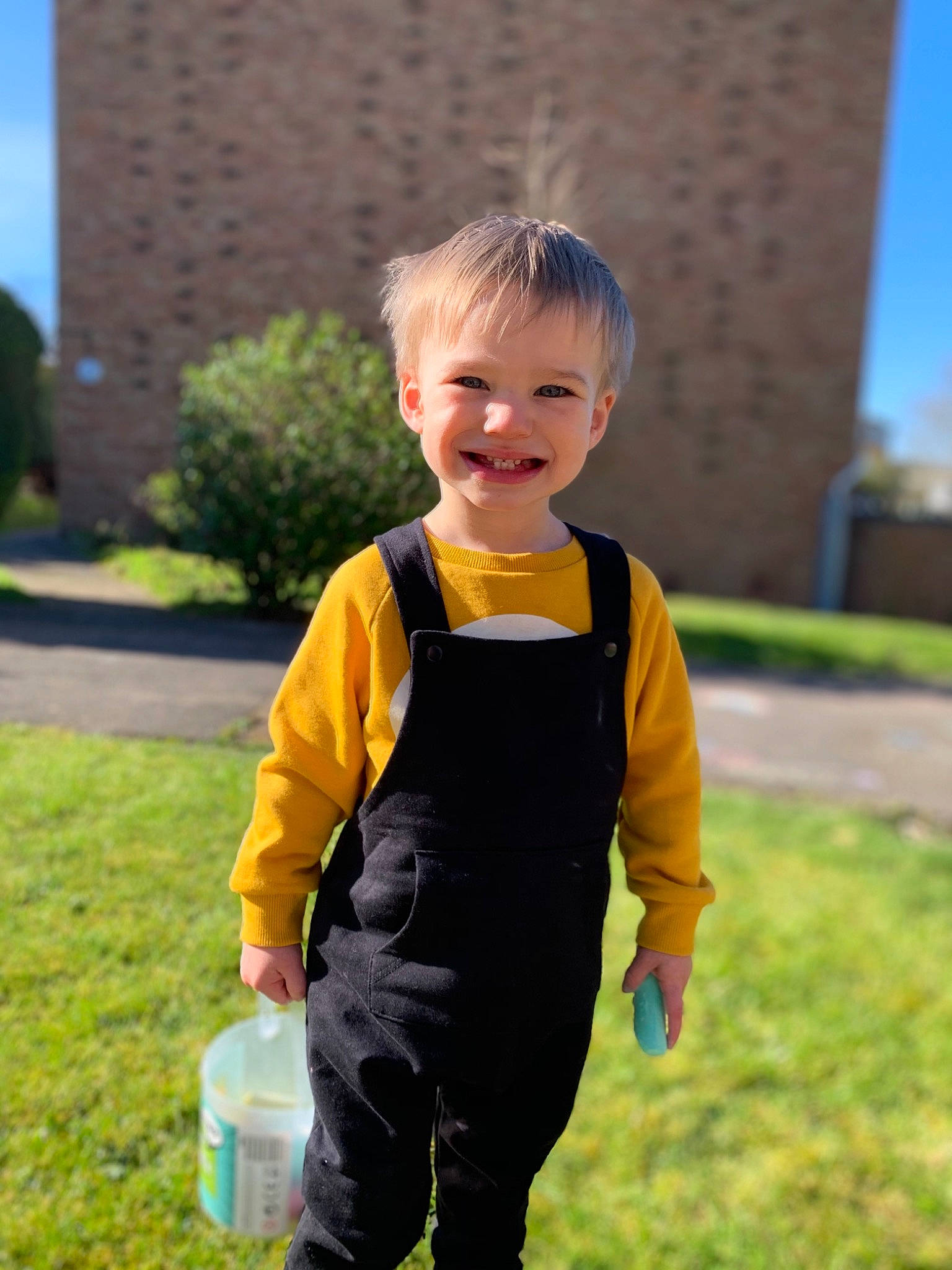 Otis is registered to the contest to win money with this photo: blond, child, dress, grass, joint, joy, outerwear, person, personal_protective_equipment, plant, play, recreation, summer, toddler, vacation, yellow