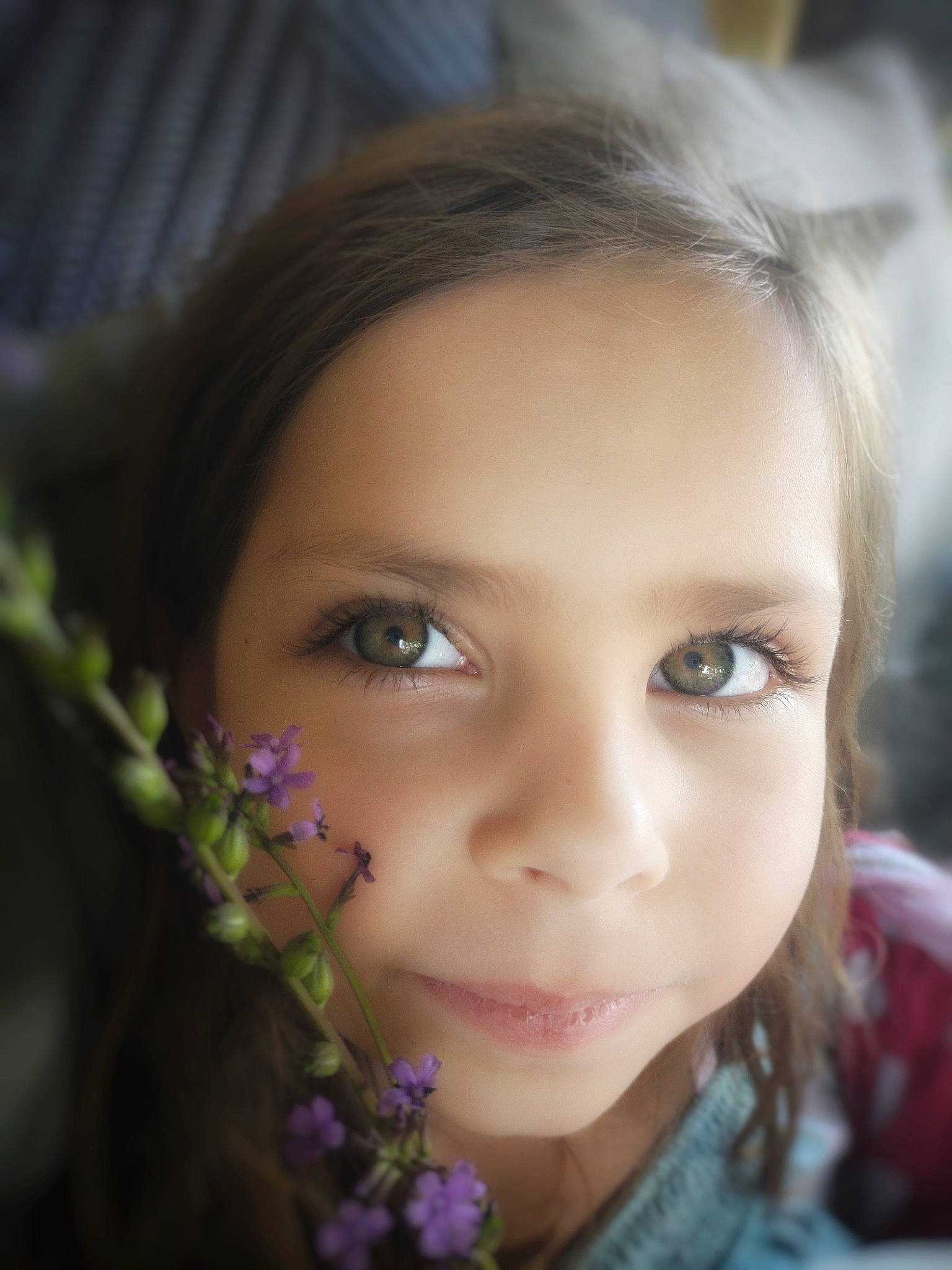 Maren is registered to the contest to win money with this photo: black_hair, brown_hair, cheek, child, chin, close_up, electric_blue, eyebrow, eyelash, flash_photography, flower, grass, happy, iris, lip, nose, people_in_nature, person, petal, plant
