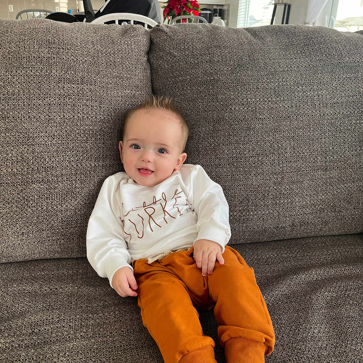 Bo G joined the competition — help win amazing prizes! baby, barefoot, casual_clothing, child, couch, cozy, cute, furniture, happy, home, indoor, infant, living_room, pants, person, relaxing, seated, small_person, smile, sweatshirt