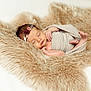 baby, blanket, cozy, cute, delicate, flower, fur_rug, headband, indoors, infant, newborn, peaceful, portrait, resting, skin, sleeping, soft_texture, tiny_feet, warm, wrapped
