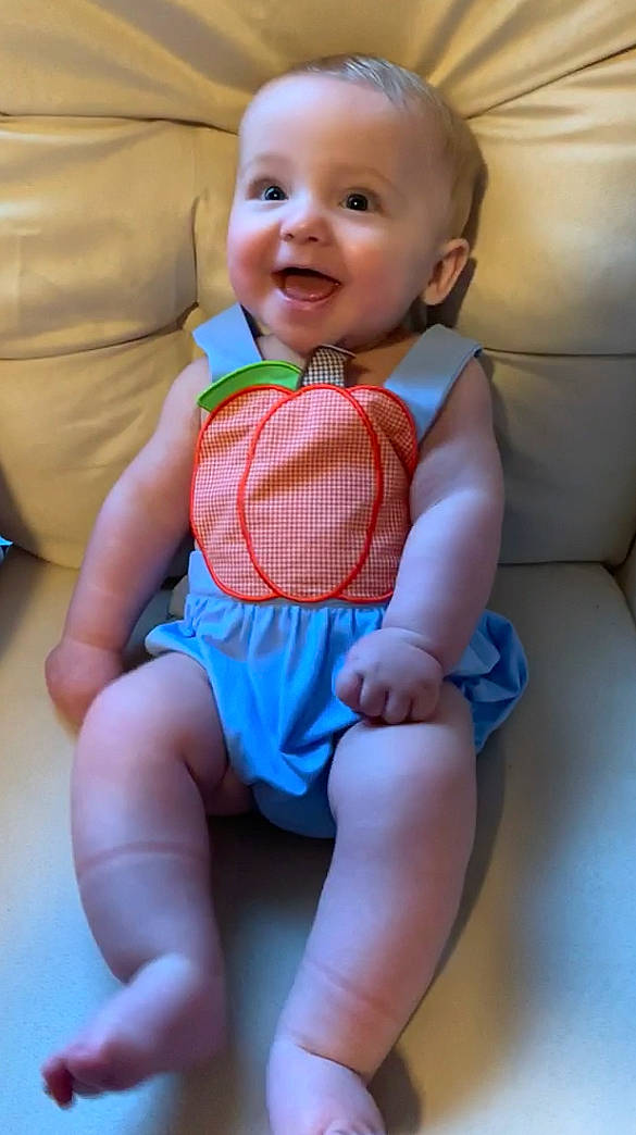 Rush is registered to the contest to win money with this photo: baby, baby_products, baby_toddler_clothing, cheek, child, leg, person, play, product, sitting, skin, smile, thigh, toddler